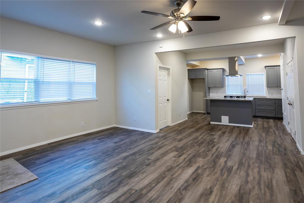 4522 Reiger Avenue Dallas, TX 75246 - Photo 15 of 37 Kitchen with dark hardwood / wood-style floors, a kitchen island, island range hood, and gray cabinetry