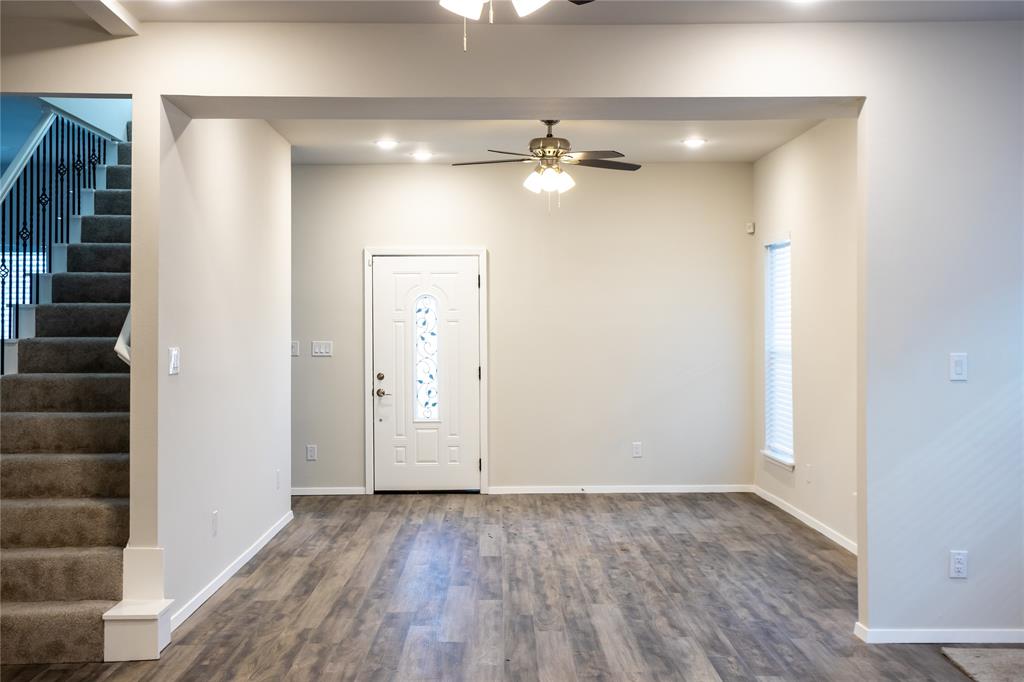 4522 Reiger Avenue Dallas, TX 75246 - Photo 19 of 37 Entryway featuring dark wood-type flooring, ceiling fan, and a healthy amount of sunlight
