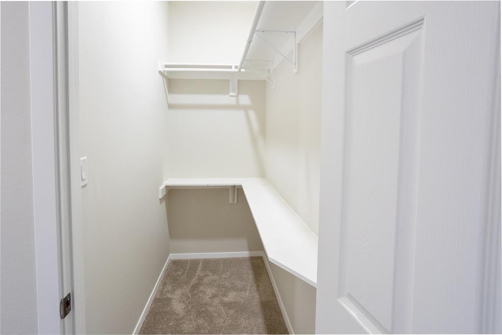 4522 Reiger Avenue Dallas, TX 75246 - Photo 22 of 37 Walk in closet featuring carpet floors