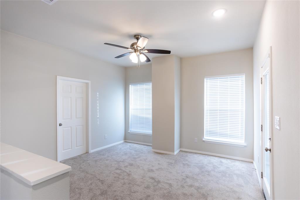 4522 Reiger Avenue Dallas, TX 75246 - Photo 23 of 37 Unfurnished room featuring light carpet and ceiling fan