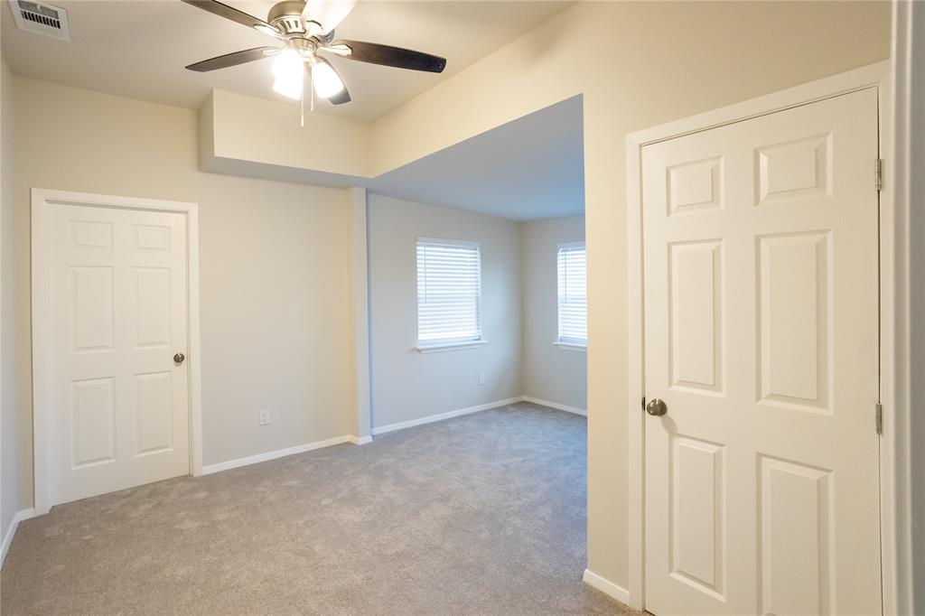 4522 Reiger Avenue Dallas, TX 75246 - Photo 24 of 37 Empty room with light carpet and ceiling fan