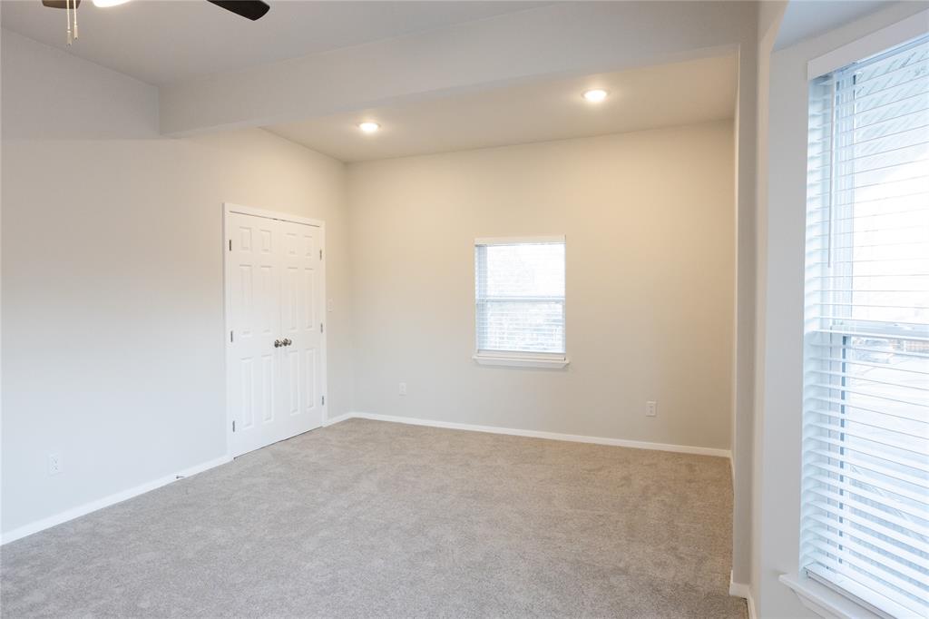 4522 Reiger Avenue Dallas, TX 75246 - Photo 25 of 37 Carpeted spare room featuring ceiling fan