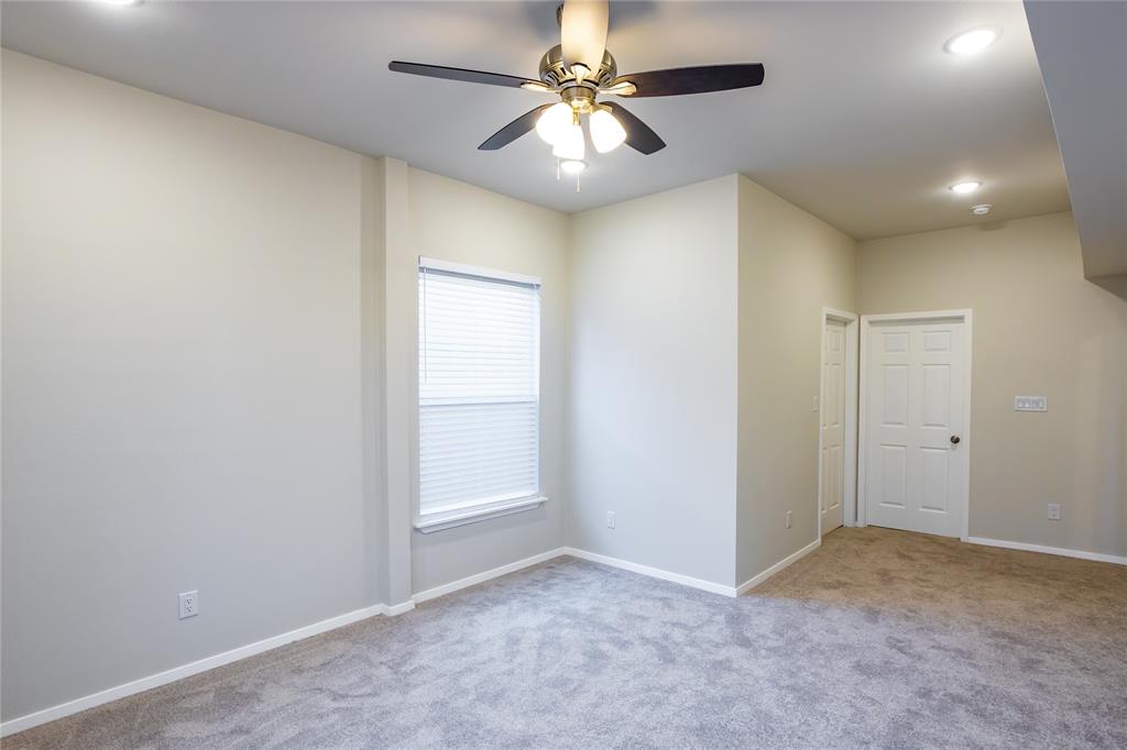 4522 Reiger Avenue Dallas, TX 75246 - Photo 28 of 37 Unfurnished room with light carpet and ceiling fan