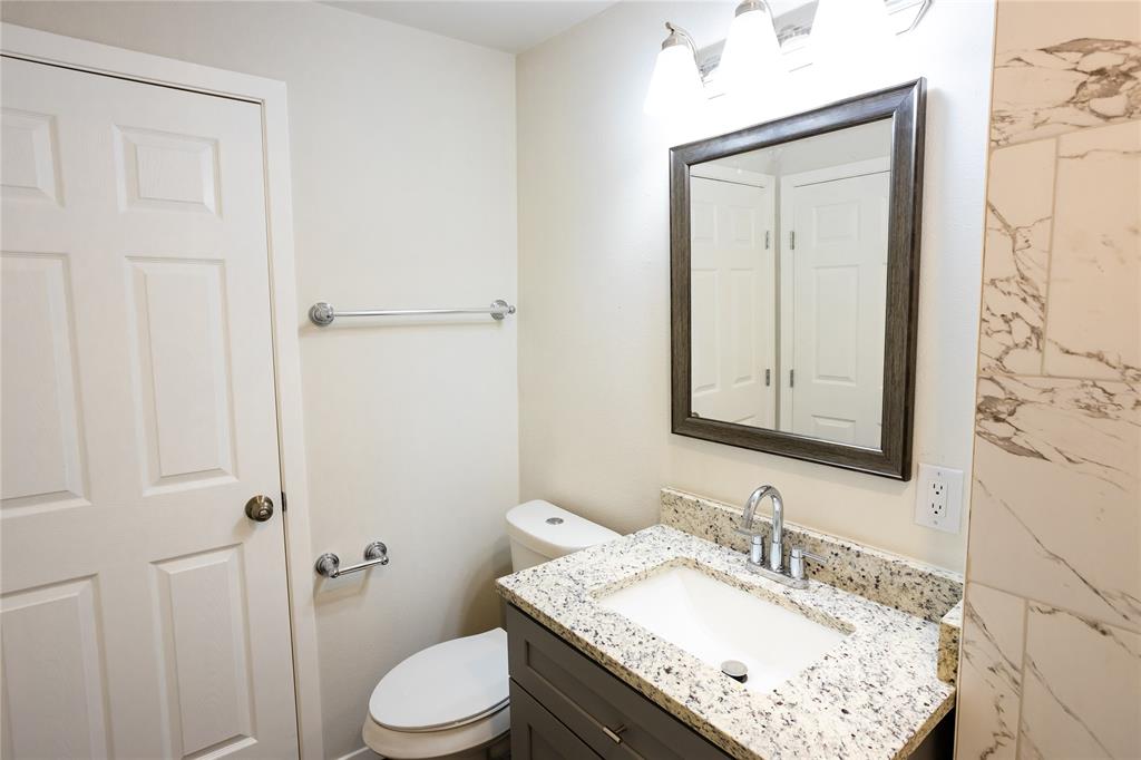 4522 Reiger Avenue Dallas, TX 75246 - Photo 31 of 37 Bathroom featuring vanity and toilet