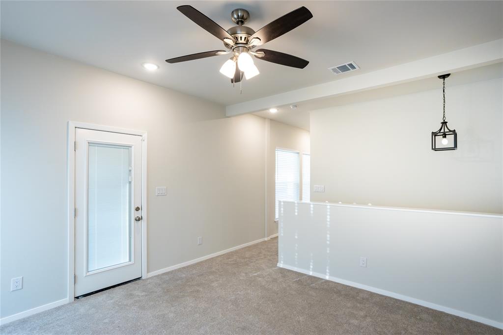 4522 Reiger Avenue Dallas, TX 75246 - Photo 34 of 37 Empty room with light carpet and ceiling fan
