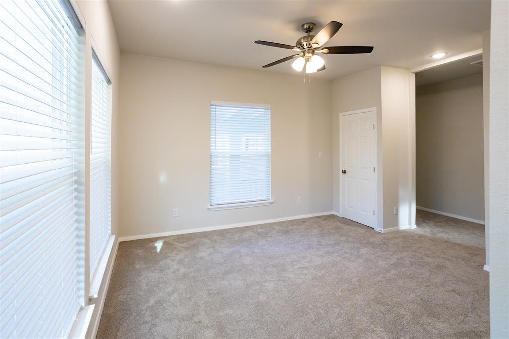 4522 Reiger Avenue Dallas, TX 75246 - Photo 35 of 37 Carpeted spare room with ceiling fan and a wealth of natural light