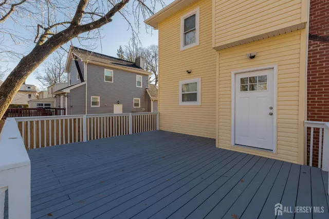 a view of a house with wooden deck