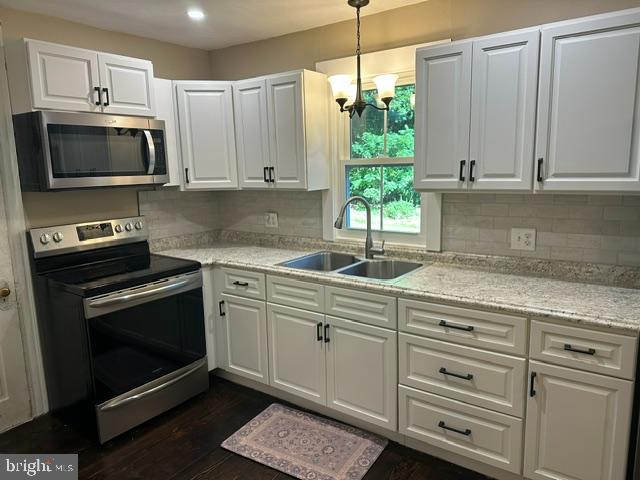 2185 Welsh Road Mohnton, PA 19540 - Photo 11 of 21 a kitchen with granite countertop white cabinets stainless steel appliances and a window