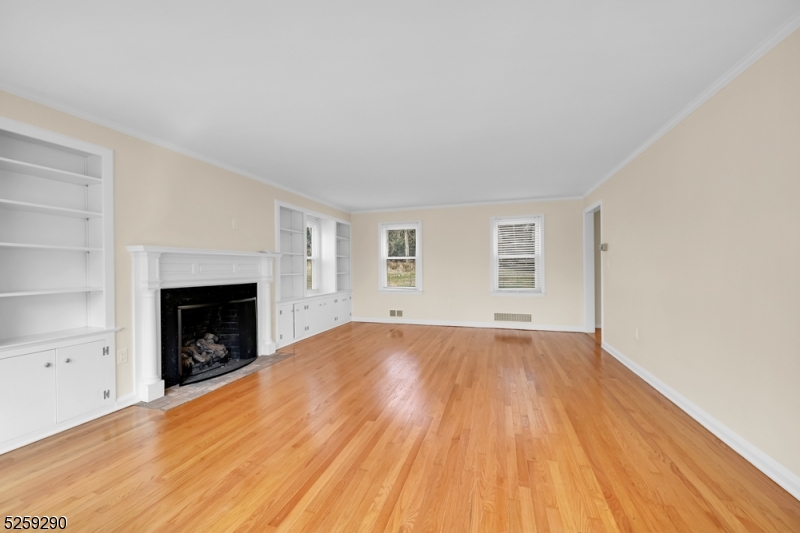 72 Youngs Road Basking Ridge, NJ 07920 - Photo 13 of 31 a view of an empty room with wooden floor fireplace and a window