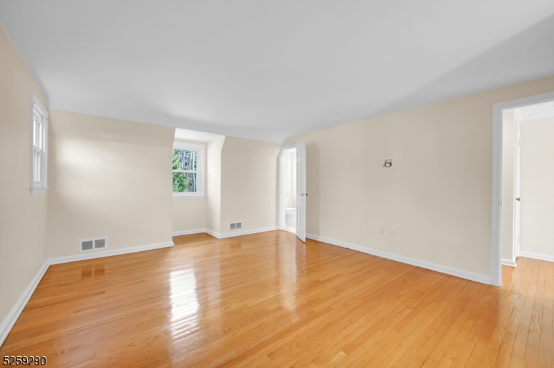 72 Youngs Road Basking Ridge, NJ 07920 - Photo 22 of 31 an empty room with wooden floor and windows