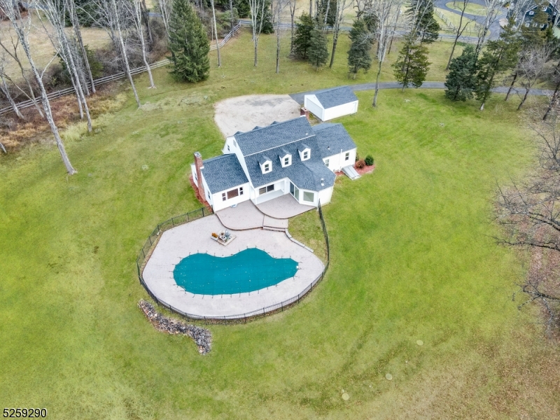 72 Youngs Road Basking Ridge, NJ 07920 - Photo 4 of 31 a view of a swimming pool in he middle of the green field