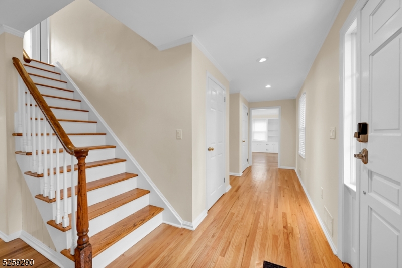 72 Youngs Road Basking Ridge, NJ 07920 - Photo 6 of 31 a view of a hallway with wooden floor and staircase