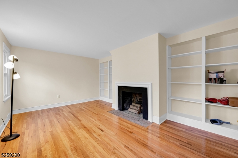 72 Youngs Road Basking Ridge, NJ 07920 - Photo 7 of 31 a view of empty room with wooden floor and fireplace