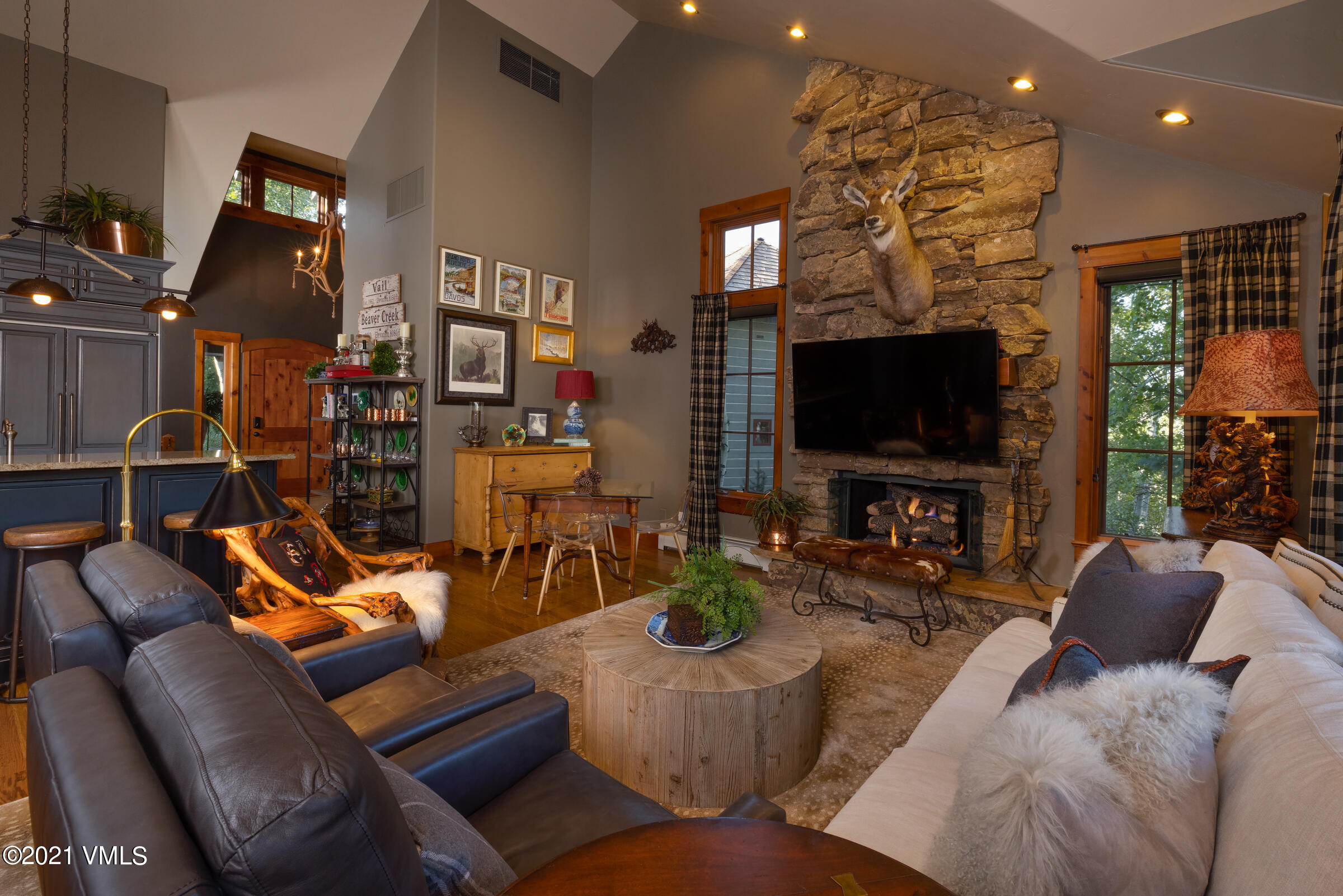 264 Bachelor Ridge Road Avon, CO 81620 - Photo 2 of 21 a living room with furniture a flat screen tv and kitchen view