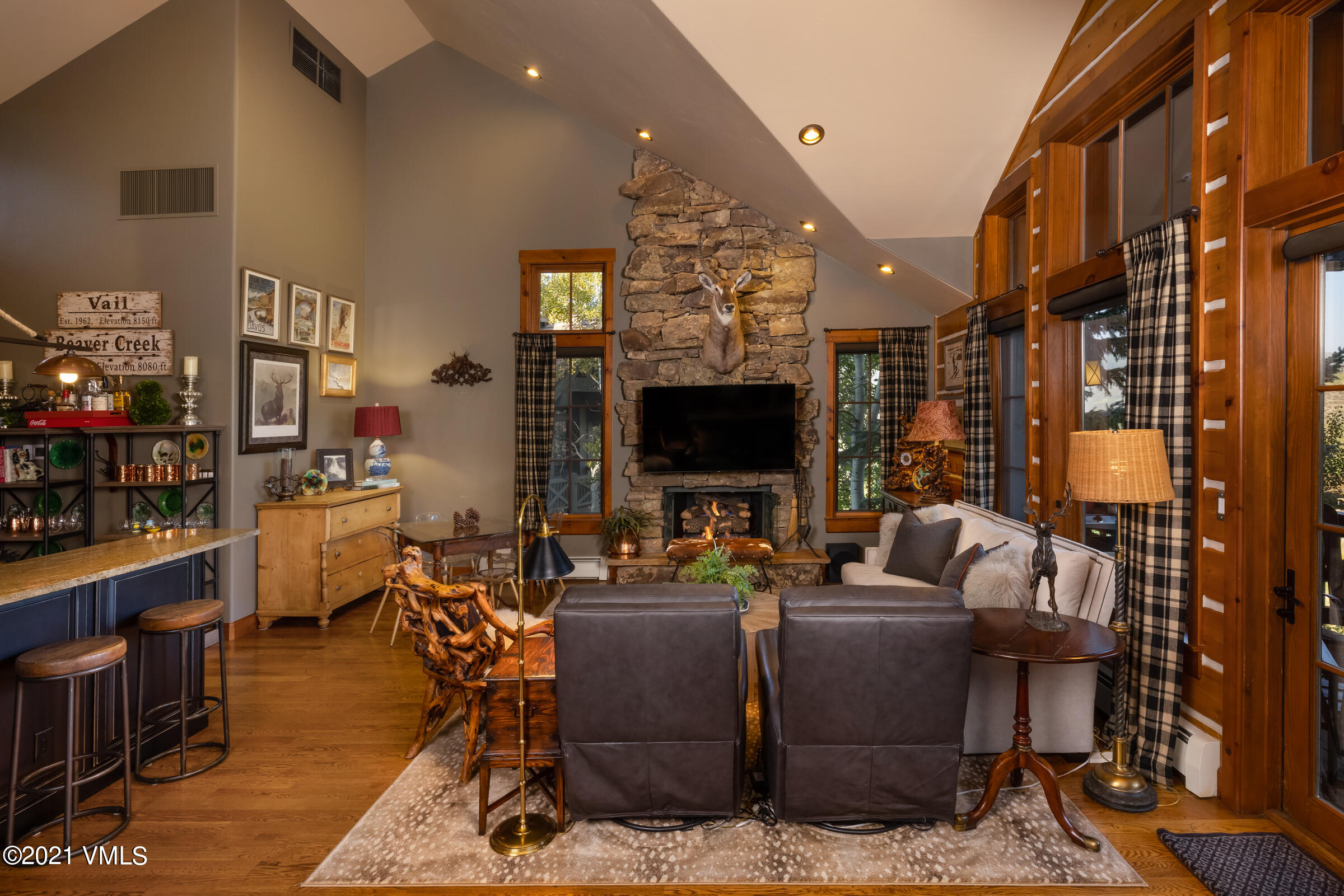 264 Bachelor Ridge Road Avon, CO 81620 - Photo 8 of 21 a living room with furniture a flat screen tv and kitchen view