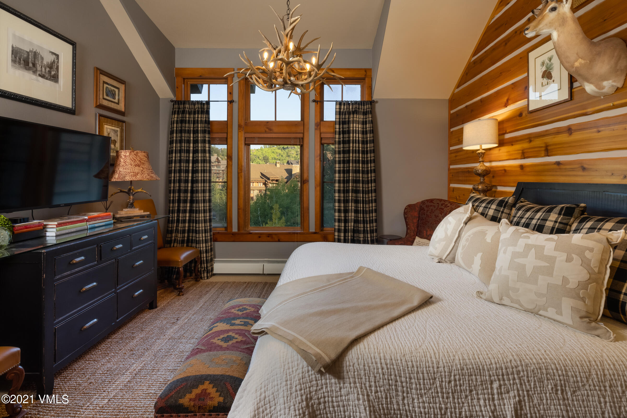 264 Bachelor Ridge Road Avon, CO 81620 - Photo 10 of 21 a bedroom with a bed and flat screen tv