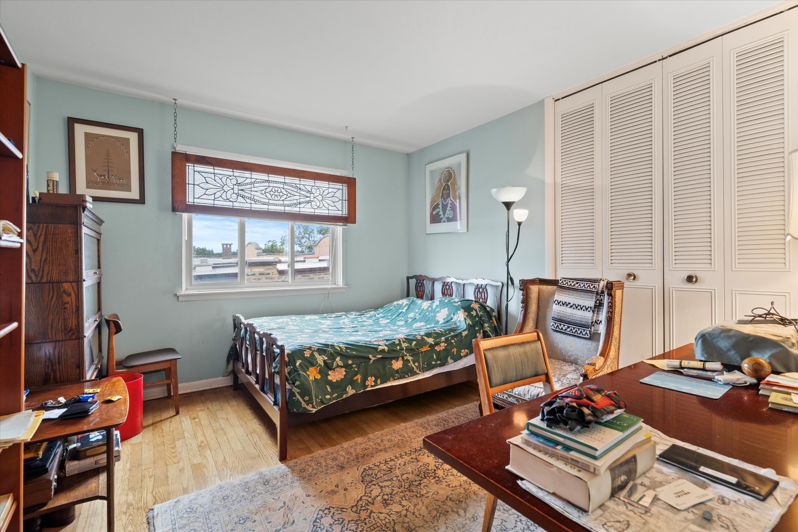 835 Ridge Avenue, Unit 507 Evanston, IL 60202 - Photo 11 of 23 a bedroom with a bed and wooden floor