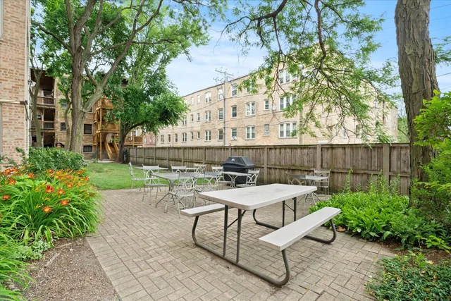 a view of a patio with couches table and chairs and potted plants