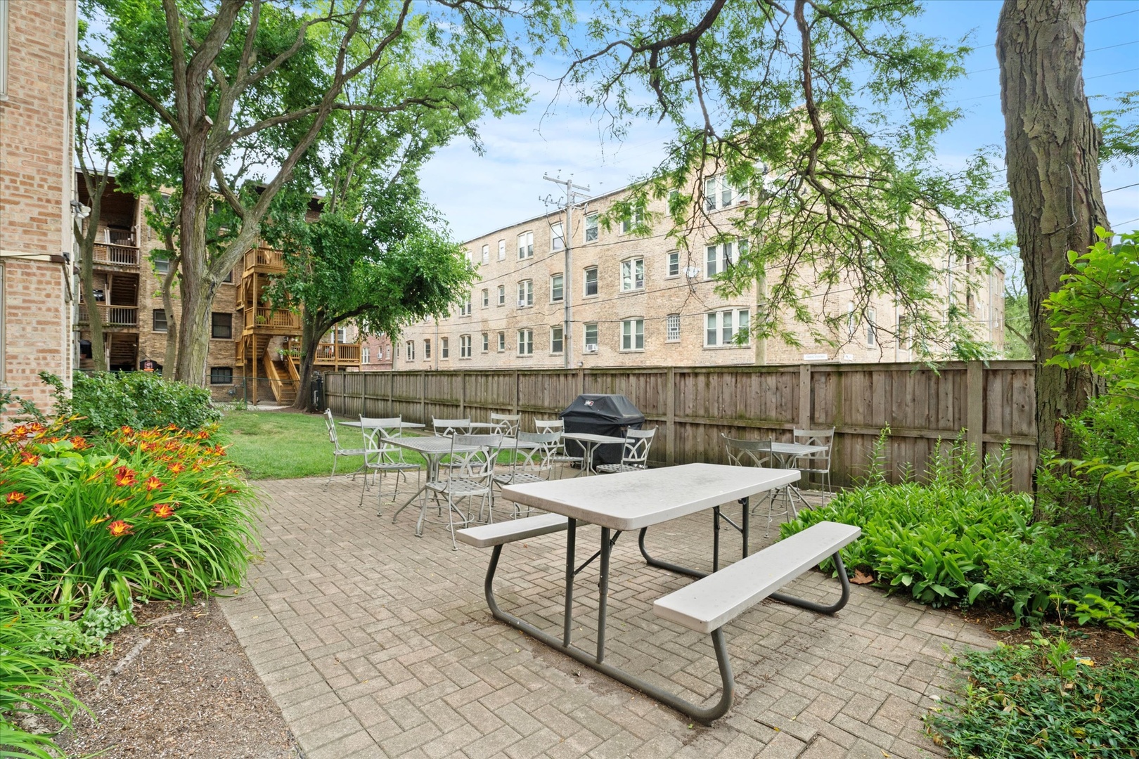 835 Ridge Avenue, Unit 507 Evanston, IL 60202 - Photo 21 of 23 a view of a patio with table and chairs and potted plants