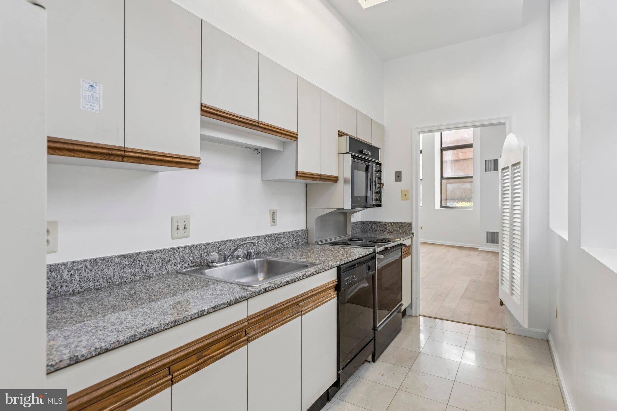 3299 K Street Northwest, Unit 304 Washington, DC 20007 - Photo 14 of 31 a kitchen with stainless steel appliances granite countertop a sink stove and cabinets