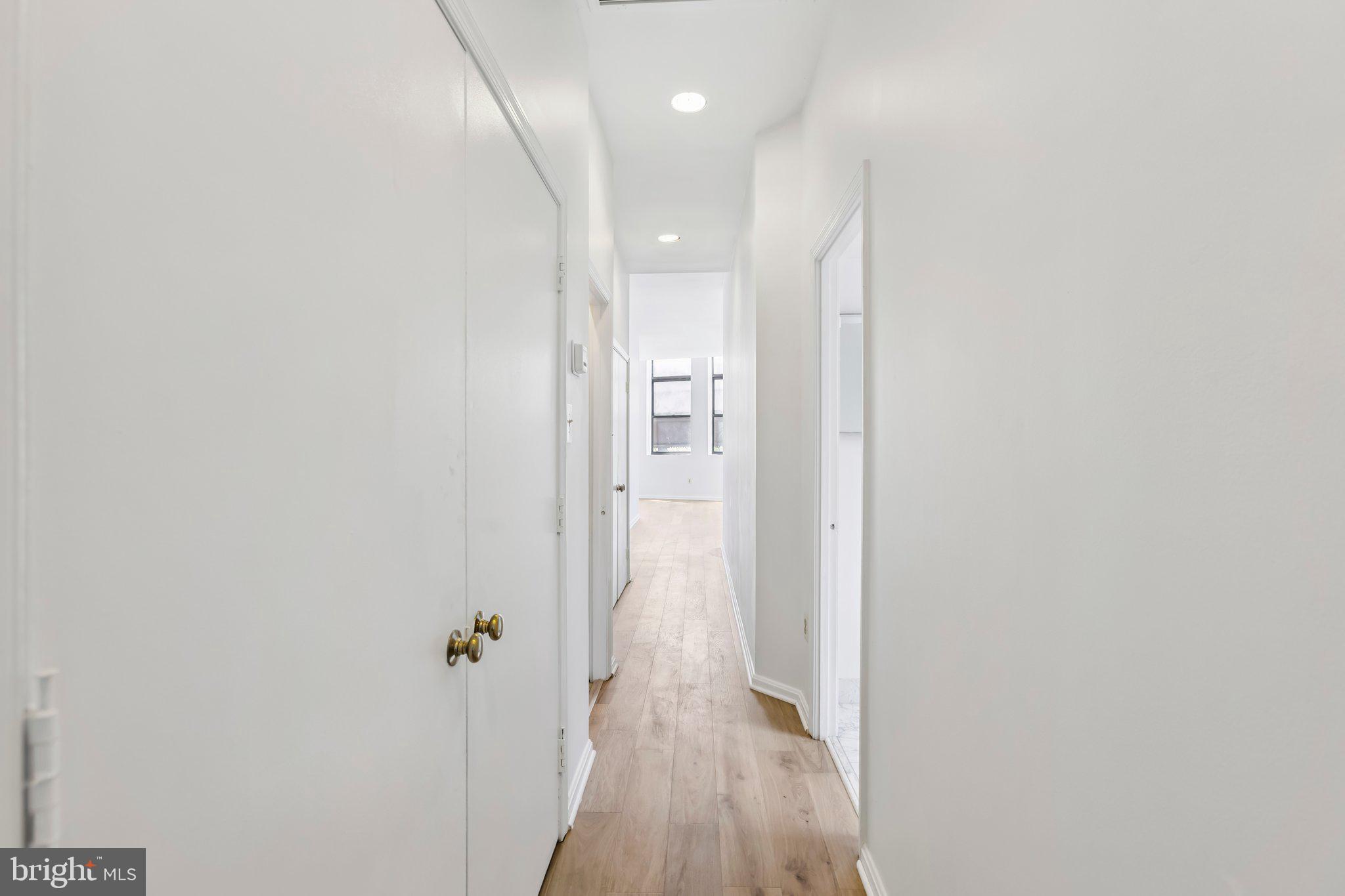 3299 K Street Northwest, Unit 304 Washington, DC 20007 - Photo 18 of 31 a view of a hallway with wooden floor and a bathroom