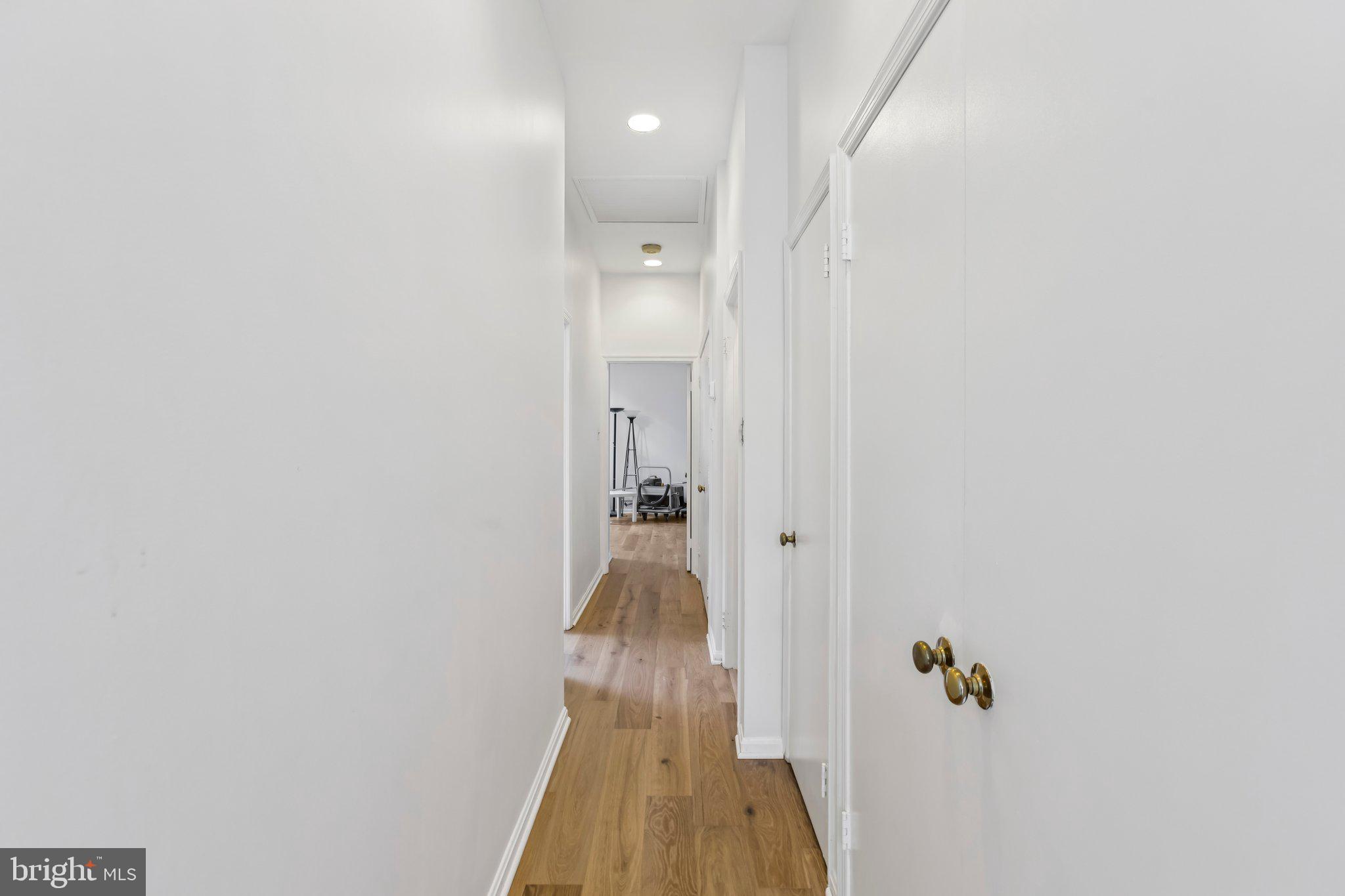3299 K Street Northwest, Unit 304 Washington, DC 20007 - Photo 19 of 31 a view of a hallway with wooden floor and closet