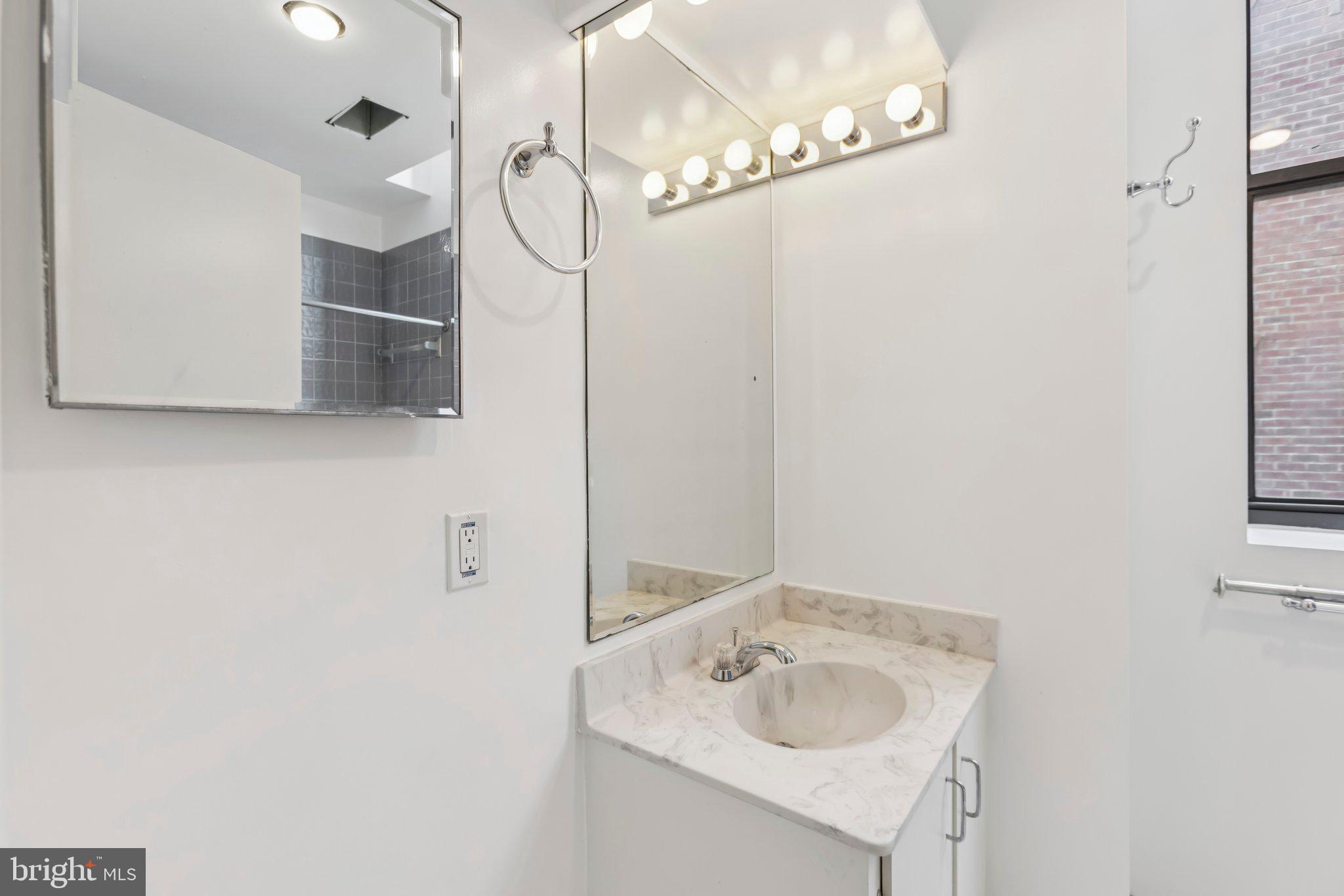 3299 K Street Northwest, Unit 304 Washington, DC 20007 - Photo 20 of 31 a bathroom with a sink and a mirror