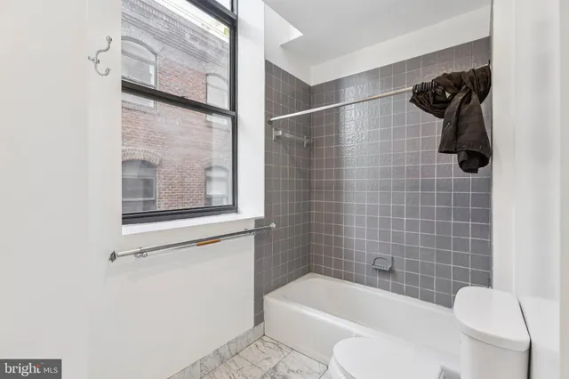 a bathroom with a toilet and a bathtub