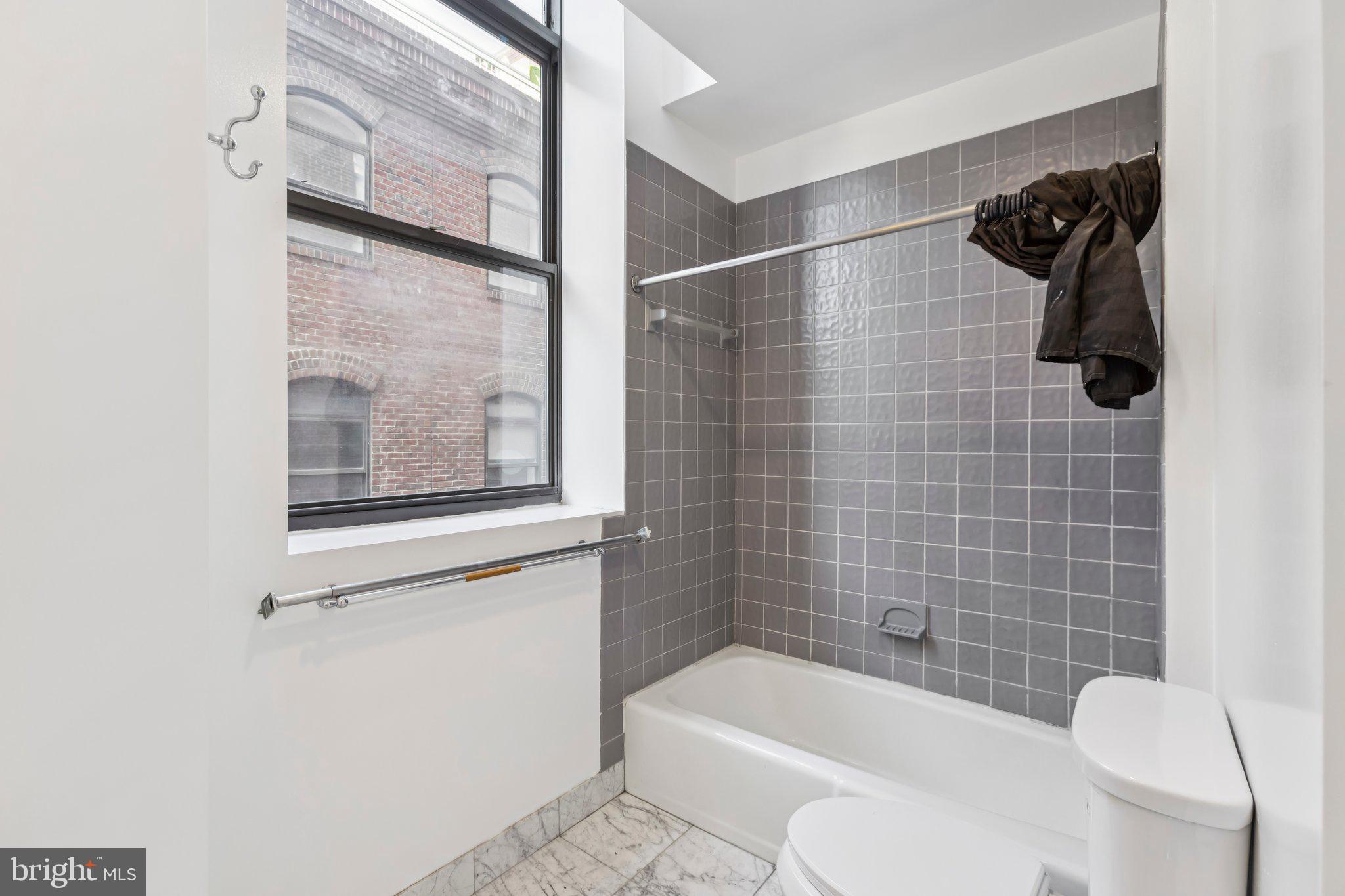 3299 K Street Northwest, Unit 304 Washington, DC 20007 - Photo 21 of 31 a bathroom with a toilet and a bathtub