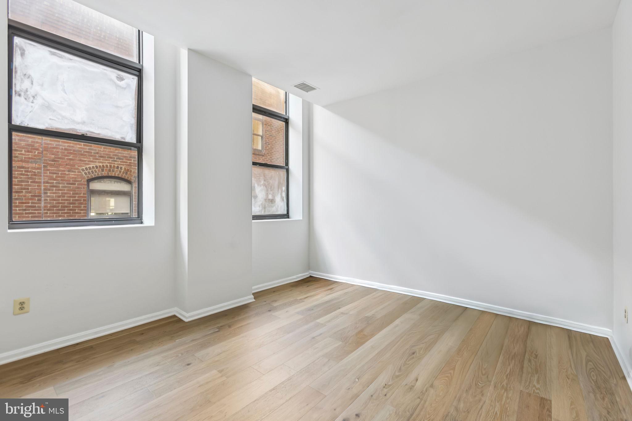 3299 K Street Northwest, Unit 304 Washington, DC 20007 - Photo 24 of 31 an empty room with wooden floor and windows
