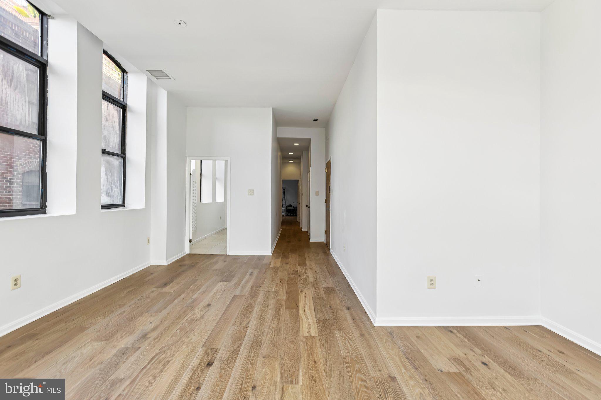 3299 K Street Northwest, Unit 304 Washington, DC 20007 - Photo 10 of 31 a view of a room with wooden floor and stairs
