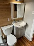 a white toilet sitting next to a bathroom sink