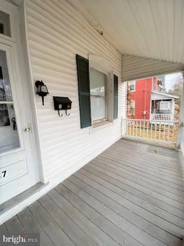 a view of a porch with wooden floor
