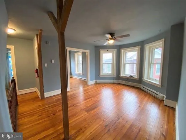 wooden floor in an empty room with a window