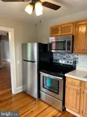 a kitchen with granite countertop wooden cabinets and stainless steel appliances