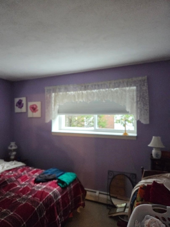 111 Grove Boston Ma, Unit 6 Boston, MA 02132 - Photo 10 of 14 a bedroom with a bed and a window