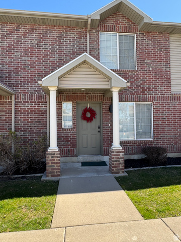 1115 North Main Street Bountiful, UT 84010 - Photo 8 of 17 Brick exterior featuring an entryway portico with two columns and a paneled front door