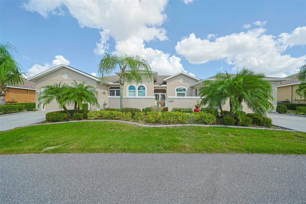 2264 Sifield Greens Way Sun City Center, FL 33573 - Photo 1 of 1 a front view of a house with garden
