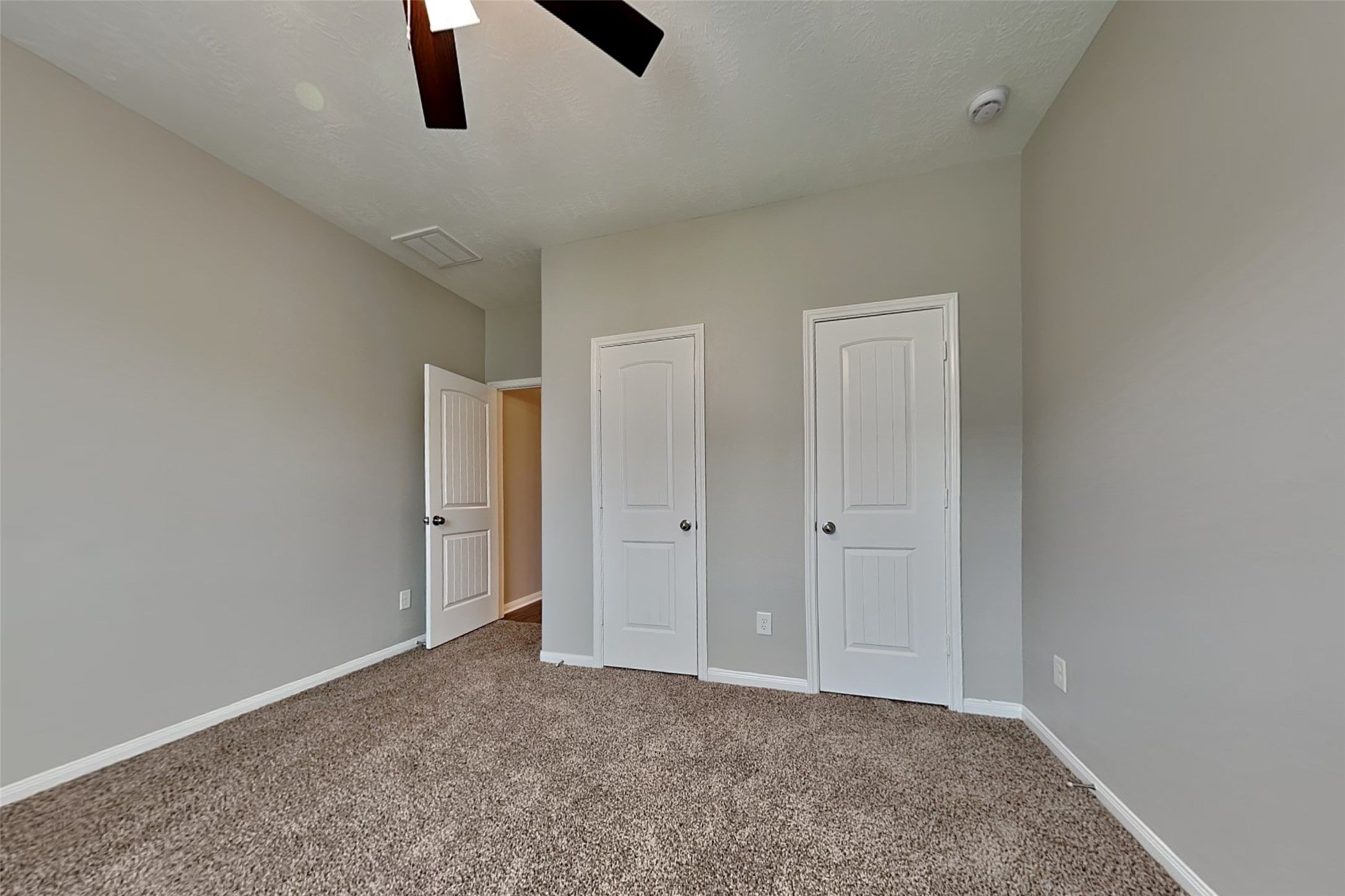 30710 Basil Trace Drive Spring, TX 77386 - Photo 13 of 18 an empty room with closet and a chandelier fan