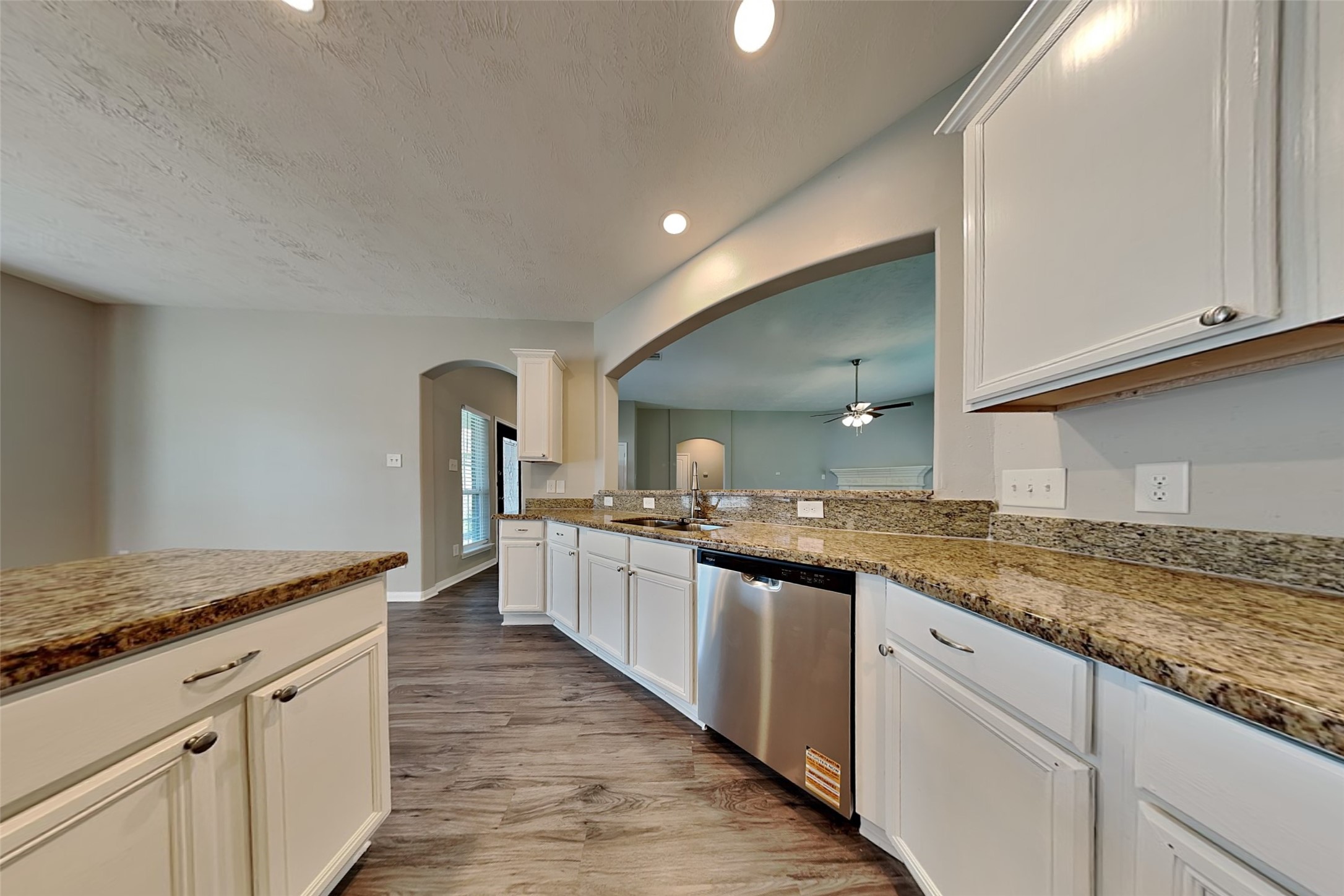 30710 Basil Trace Drive Spring, TX 77386 - Photo 4 of 18 a large kitchen with granite countertop a sink and dishwasher with a stove