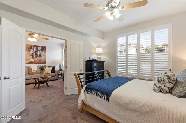 a bedroom with a large bed and a window