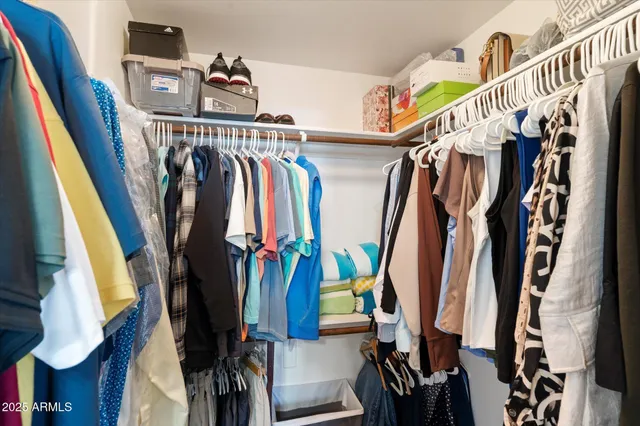 a view of walk in closet with clothes