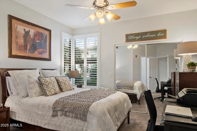 a bedroom with a bed and a chandelier