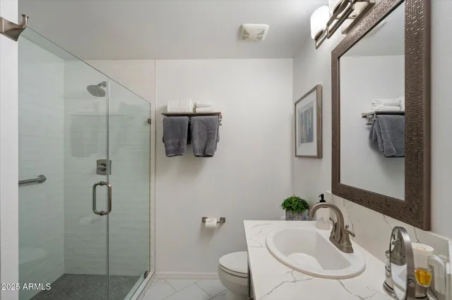 a bathroom with a sink toilet and shower