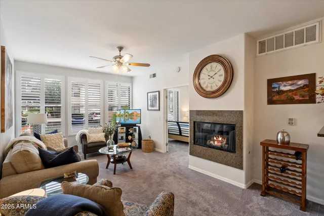 a living room with furniture a clock and a fireplace