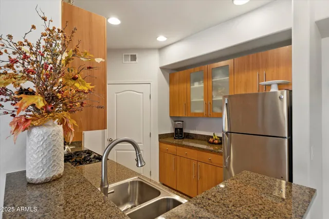 a kitchen with a refrigerator and a sink