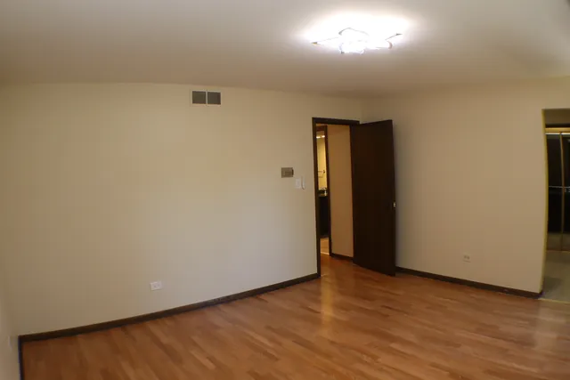 a bedroom with a bed and cupboard