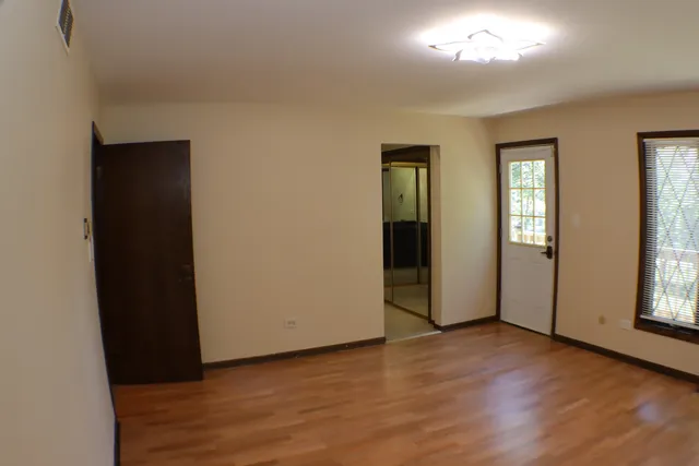 a bedroom with a bed and a lamp on table