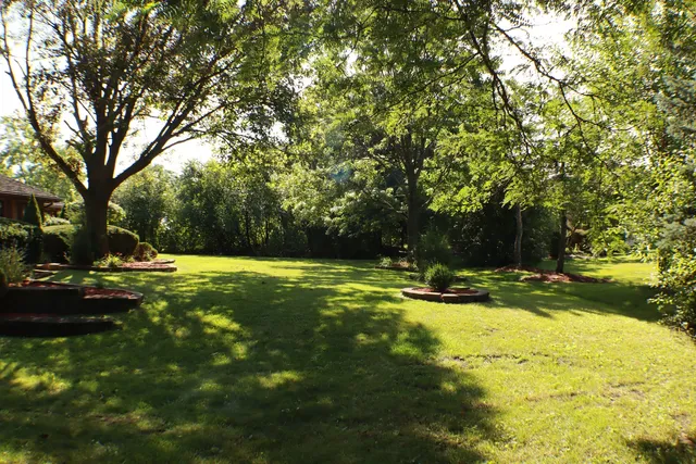 an aerial view of a house with outdoor space