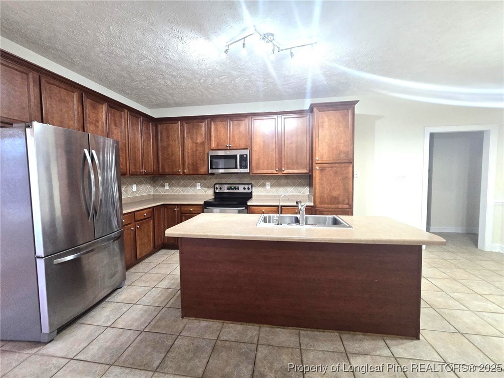 3941 Birkhoff Lane Fayetteville, NC 28304 - Photo 14 of 41 a kitchen with kitchen island granite countertop a stove cabinets and refrigerator